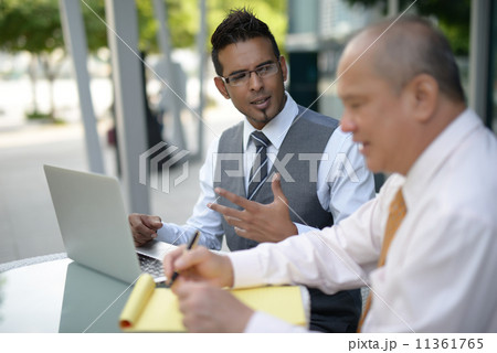Businessman having discussion using computer Businessman having discussion using computer 11361765