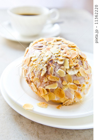 bread with almond slices pile on top and cup of coffee bread with almond slices pile on top and cup of coffee 11362220