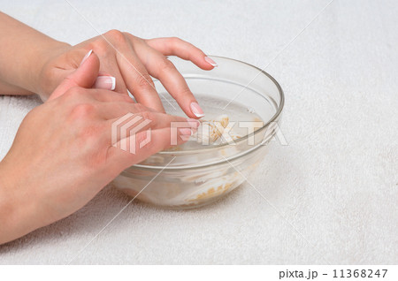 Hands in water with seashells 11368247