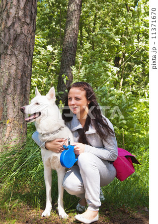 The young woman with a white dog on the nature The young woman with a white dog on the nature 11371670