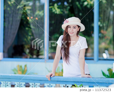 young woman relaxing on a balcony young woman relaxing on a balcony 11372523