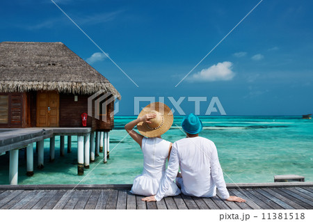 Couple on a beach jetty at Maldives 11381518