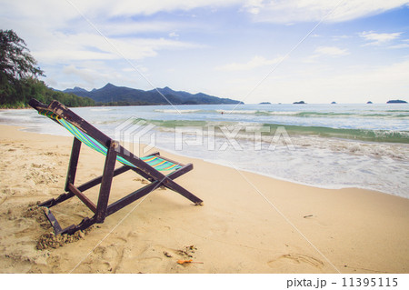 Wooden chairs rest at the beach Wooden chairs rest at the beach 11395115