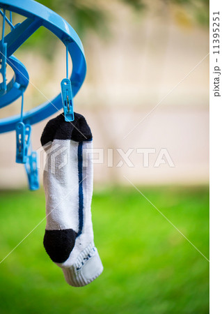 white sock on washing line with wooden clothes peg and bubbles white sock on washing line with wooden clothes peg and bubbles 11395251