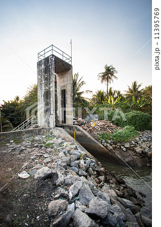 Small ditch with a weir between meadows in the thailand 11395769