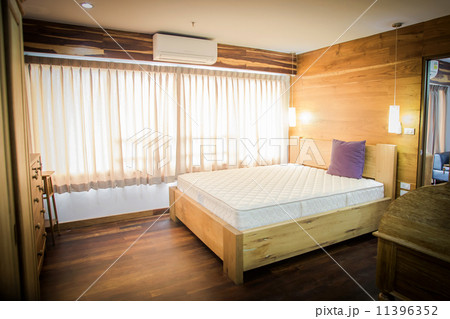 bedroom interior with white bedding and hardwood floor 11396352