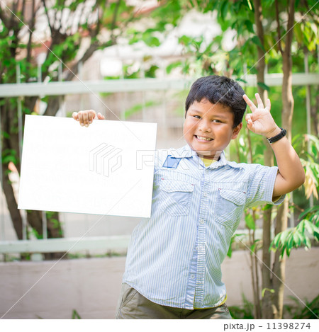 teen boys and girls, showing blank placard board to write it on teen boys and girls, showing blank placard board to write it on 11398274