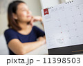 Beautiful pregnant woman looking at the calendar for the date of 11398503
