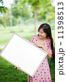 Portrait of young woman with blank white board 11398513