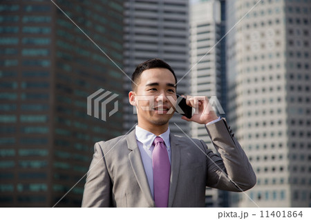 Asian businessman on mobile phone outdoor. 11401864