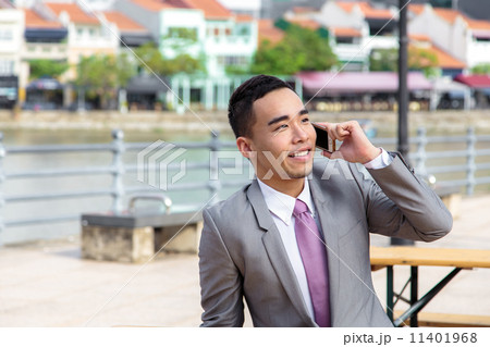 Asian businessman using mobile phone outdoor 11401968