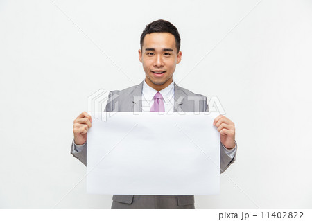 Young Asian businessman holds up a blank sign with room for adding text. Isolated on white. 11402822