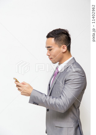 Young Asian businessman test messaging 11402962