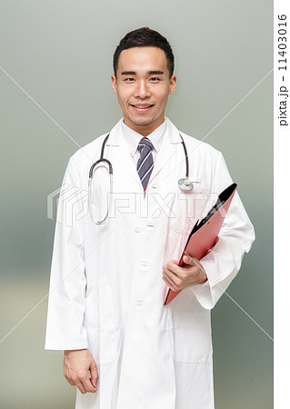 Young Asian doctor Holding a Clipboard - Isolated Young Asian doctor Holding a Clipboard - Isolated 11403016