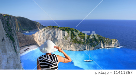 Navagio beach with woman on cliff, Zakynthos, Greece 11411867