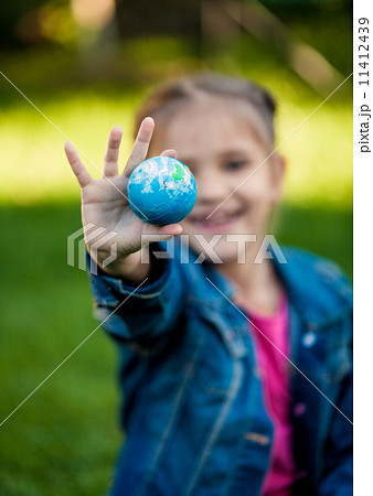 shot of girl holding Earth in hand shot of girl holding Earth in hand 11412439