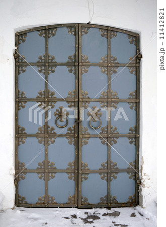 Old blue gate in the wall of the fortress 11412821
