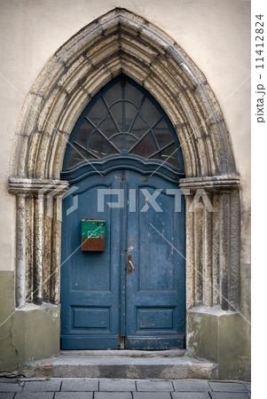 Fragment an ancient build with blue Gothic wooden door Fragment an ancient build with blue Gothic wooden door 11412824