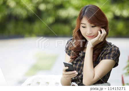 Asian Business woman using a Cell Phone 11415271