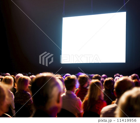 Crowd audience looking at screen 11419956