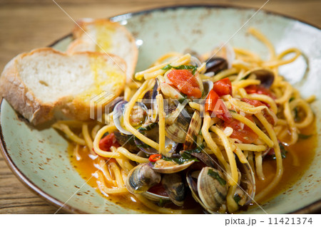 Homemade pasta with seafood and cherry tomatoes Homemade pasta with seafood and cherry tomatoes 11421374