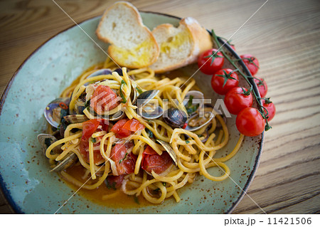 Homemade pasta with seafood and cherry tomatoes Homemade pasta with seafood and cherry tomatoes 11421506