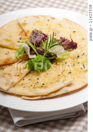 garlic pita bread pizza with salad on top 11425556