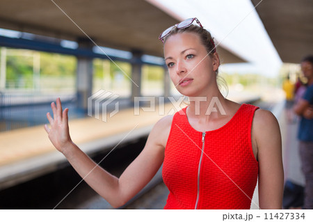 Young woman on platform of railway station. Young woman on platform of railway station. 11427334