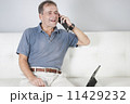 Adult male communicating with a friend on a mobile. 11429232
