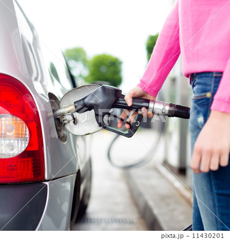 Lady pumping gasoline fuel in car at gas station. 11430201