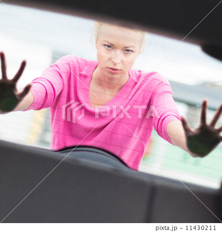 Woman pushing a car. Woman pushing a car. 11430211