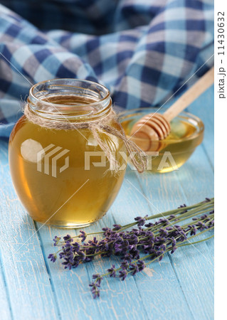 honey in a glass bowl, not painted wooden planks background 11430632