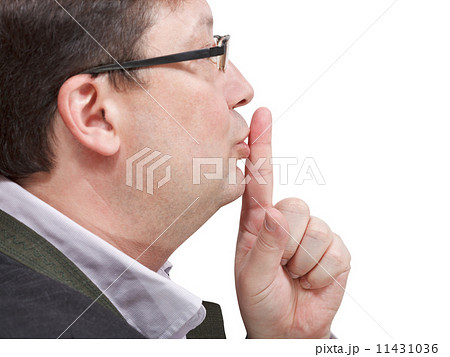 side view of businessman's finger near lips side view of businessman's finger near lips 11431036