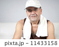 Adult male relaxes after exercising in the fitness gym. 11433158