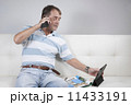 Adult Male Relaxing having a coffee and reading a magazine. 11433191