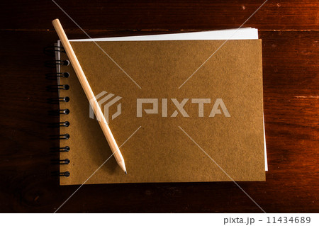 Old vintage note book with pen on wooden table Old vintage note book with pen on wooden table 11434689