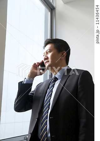 Asian businessman with mobile phone Asian businessman with mobile phone 11436454