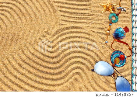 Sunglasses and different objects on the beach sand Sunglasses and different objects on the beach sand 11438857