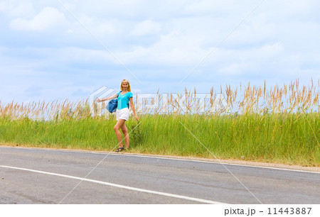 Hitchhiking girl votes on road 11443887