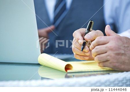 Hand and notepad taking notes Hand and notepad taking notes 11444046