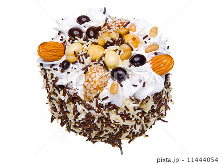 Cake with nuts and whipped cream on a white background Cake with nuts and whipped cream on a white background 11444054