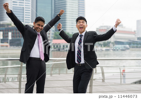 Two multi-ethnic young businessmen cum partners overjoyed by success 11446073