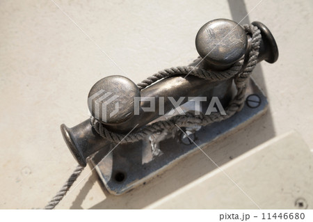 Black bollard with rope knot on yacht deck Black bollard with rope knot on yacht deck 11446680