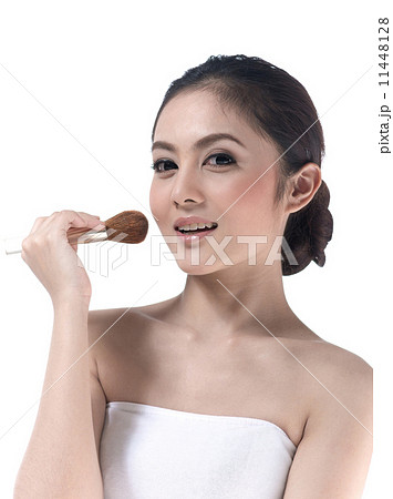 young woman makeup her face with brush 11448128