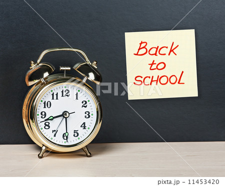 alarm clock and sticker with text back to school on the chalkboa alarm clock and sticker with text back to school on the chalkboa 11453420