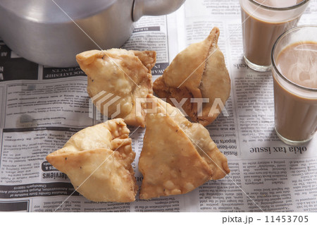 High angle view of fresh samosas and tea on table 11453705