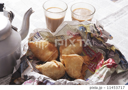 High angle view of fresh samosas and hot tea on table 11453717