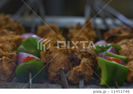 Close-up of chicken and vegetables being barbecued 11453746