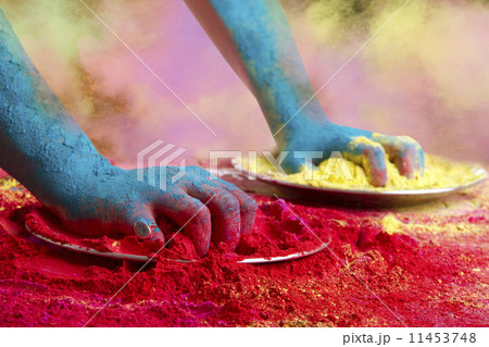 Close-up of hands holding powder paints during Holi festival 11453748