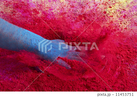 Close-up of hand splashing red powder paint during Holi festival 11453751